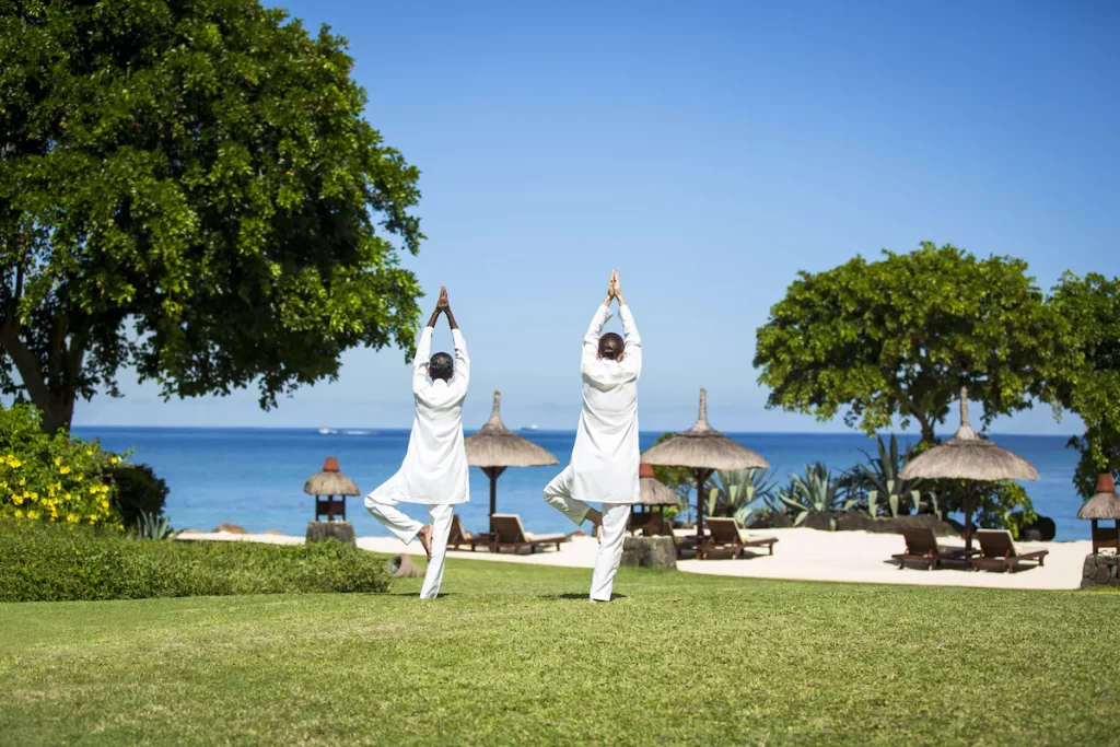 Séance de yoga face à l’océan au The Oberoi Beach Resort Mauritius, activité bien-être en plein air dans un cadre tropical de luxe